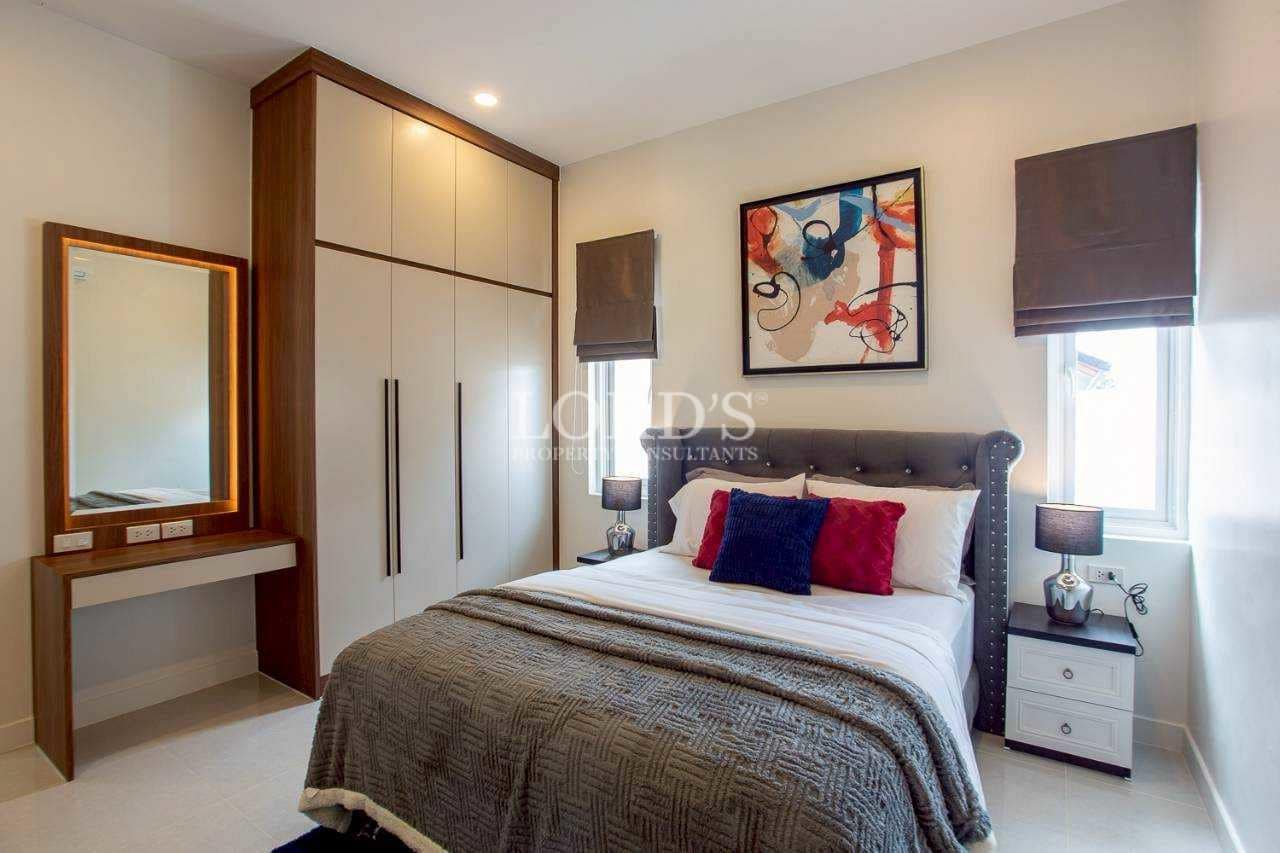 Cozy bedroom with artwork and bedside lamps