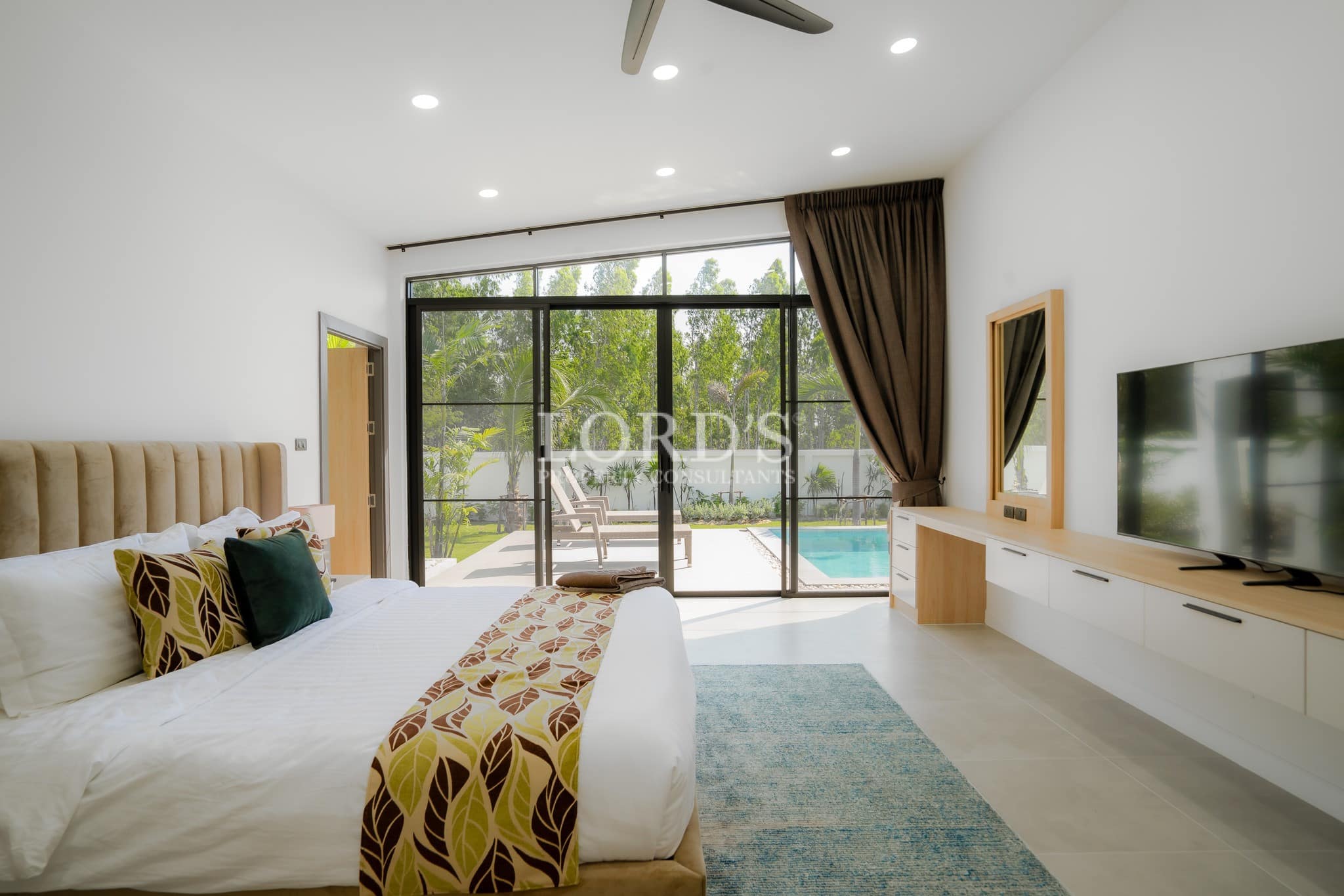Bedroom with large glass doors and garden view