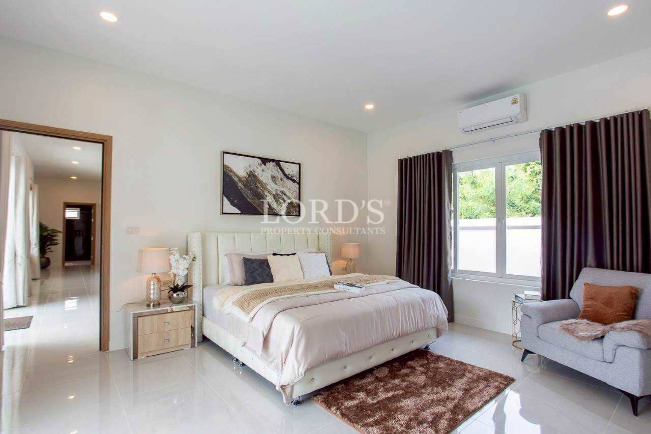 Modern bedroom with large window and decor