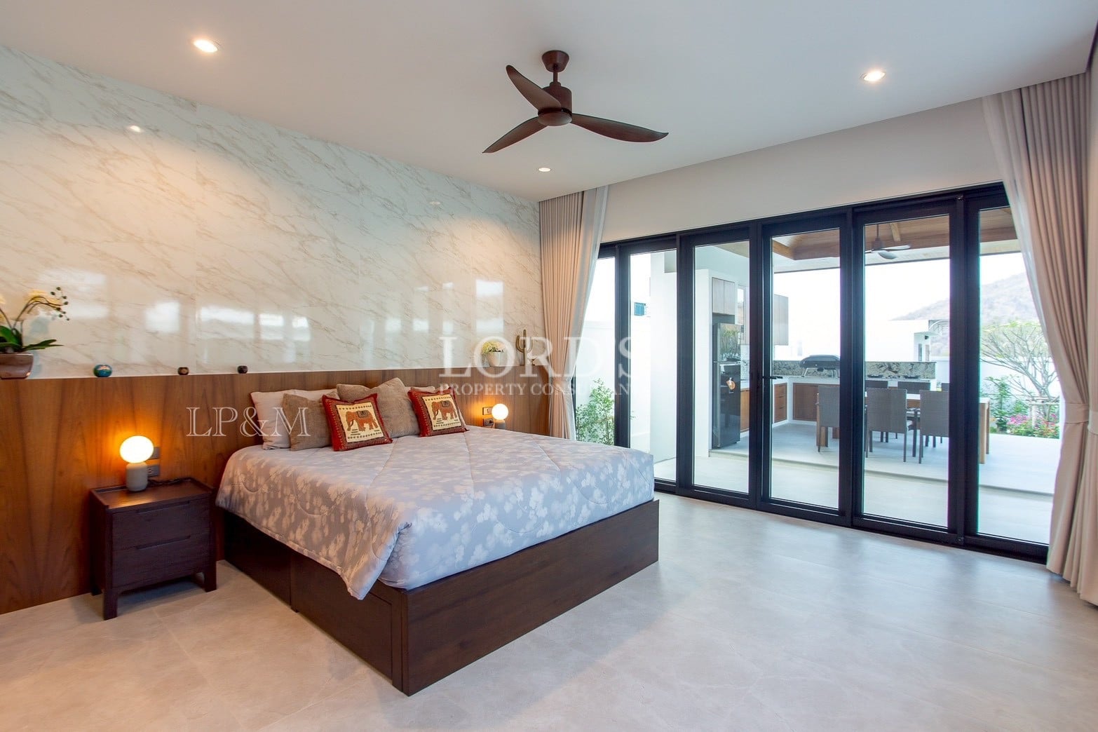 Bedroom with large windows and ceiling fan