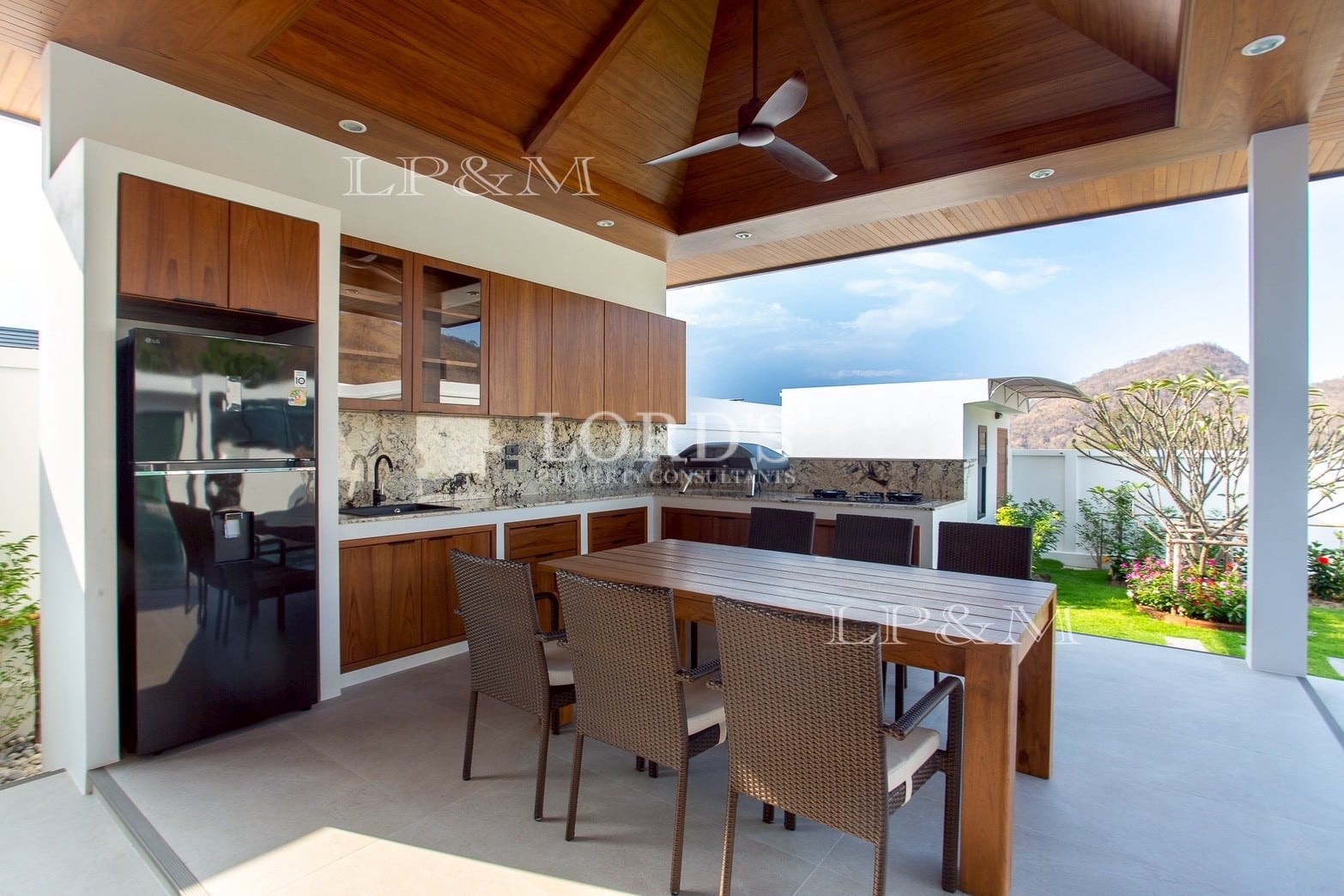 Outdoor dining area with wooden ceiling