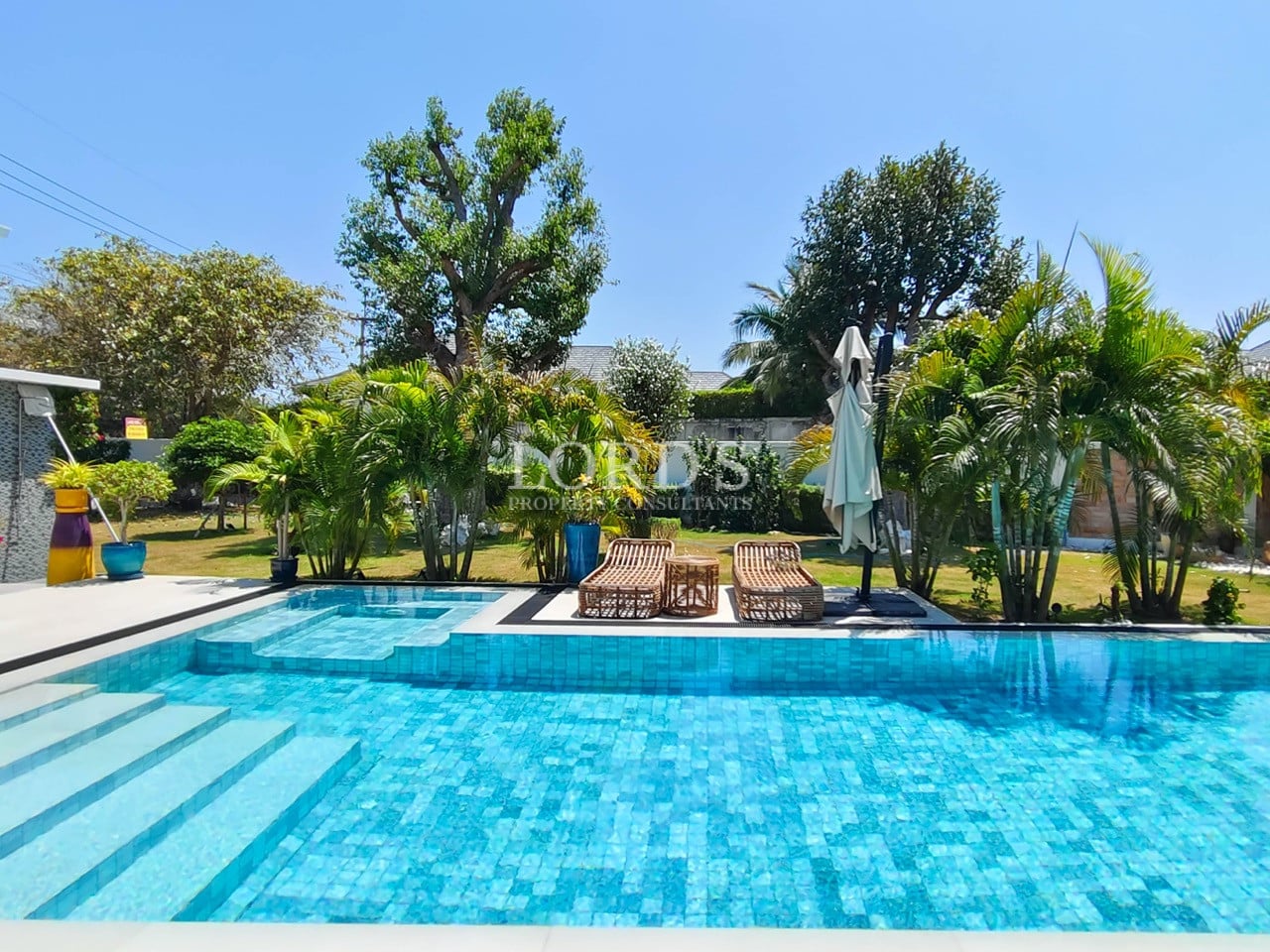 Private swimming pool with tropical landscaping