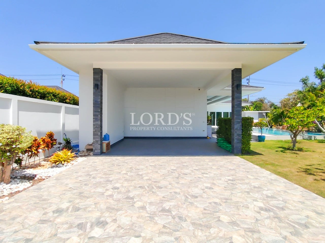 Modern villa entrance with paved driveway