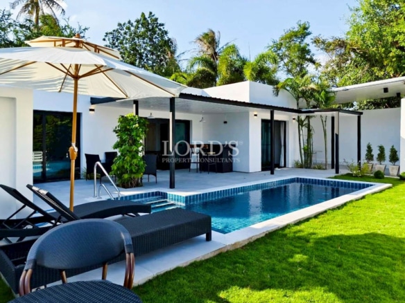 Modern luxury villa with private swimming pool and outdoor lounge area