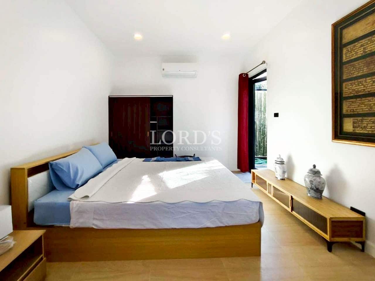 Master bedroom with wooden bed and natural light