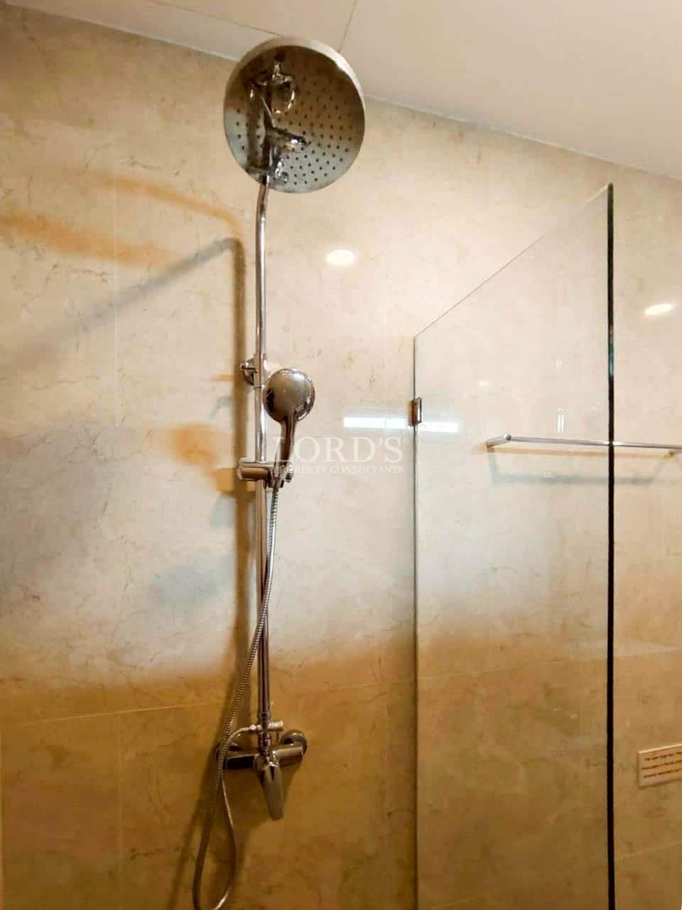 Glass shower enclosure with modern shower fixtures