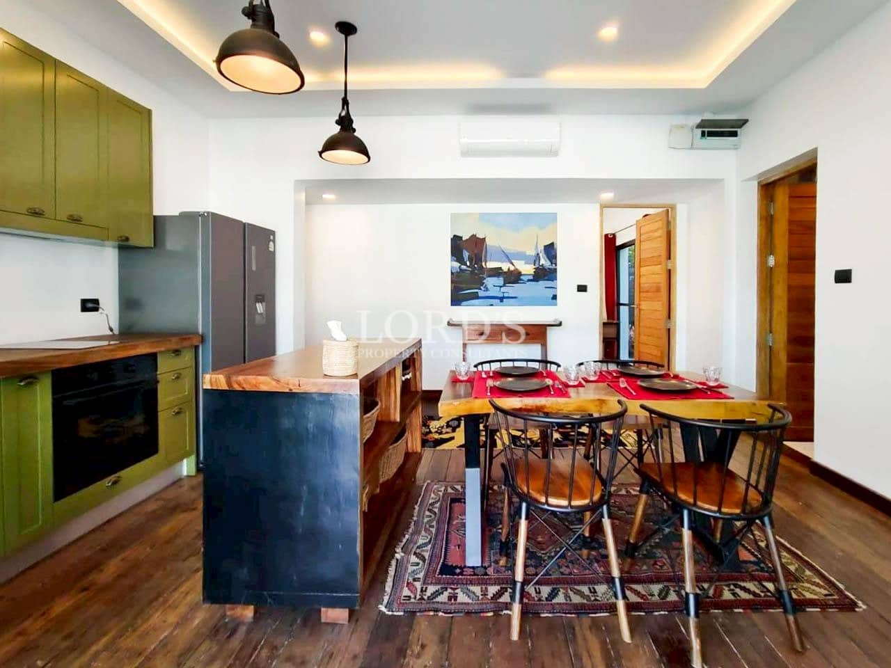 Kitchen island with bar seating and wooden floor