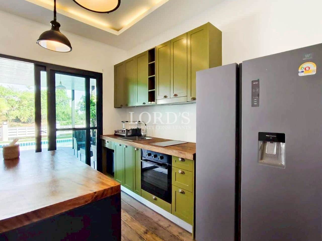 Modern kitchen with green cabinets and island