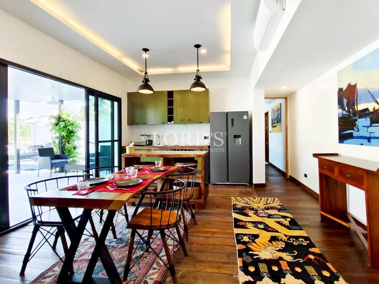 Dining table with modern chairs and pendant lights