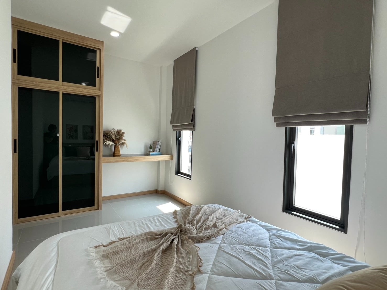 Bedroom with large window and bed