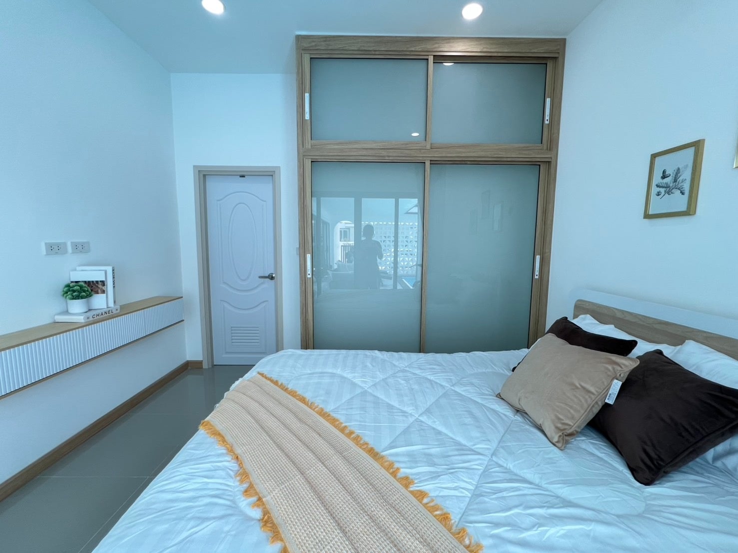 Bedroom with blue accent wall and bed