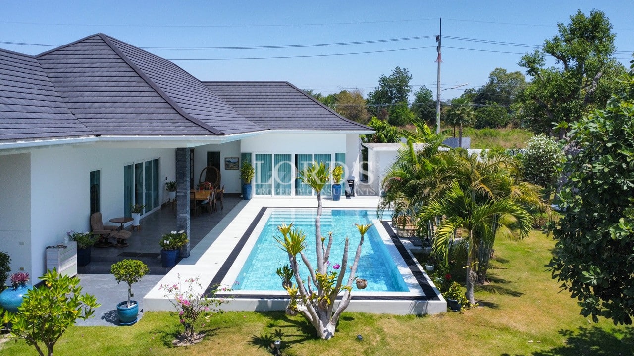 Modern villa exterior with pool courtyard, buying real estate in thailand