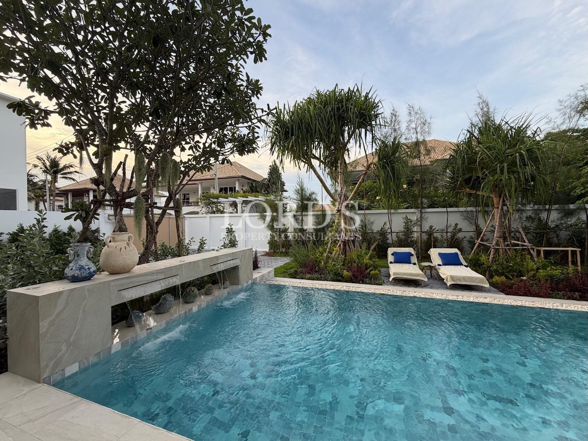 Pool with trees and outdoor seating