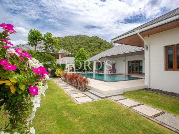 House exterior with flowers and lawn