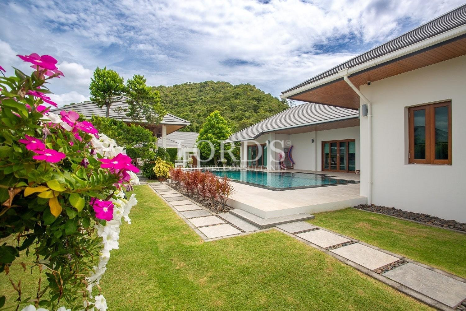 House exterior with flowers and lawn