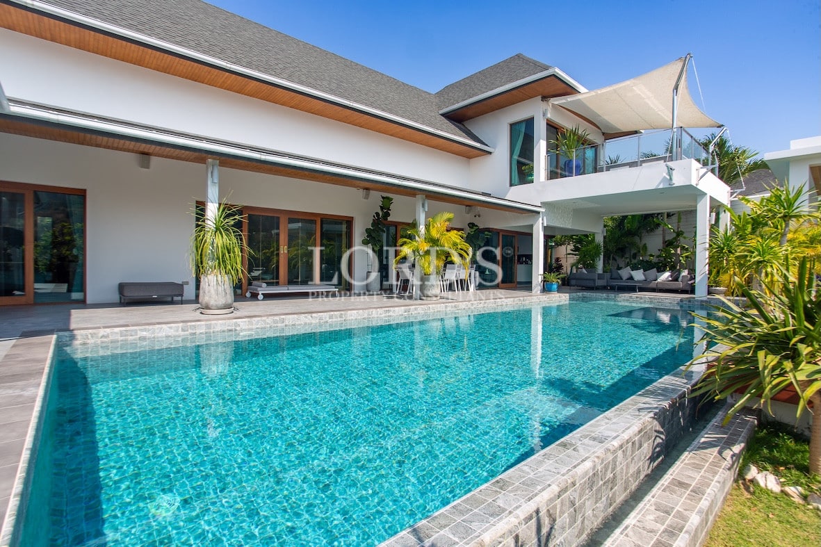 House exterior with driveway and greenery