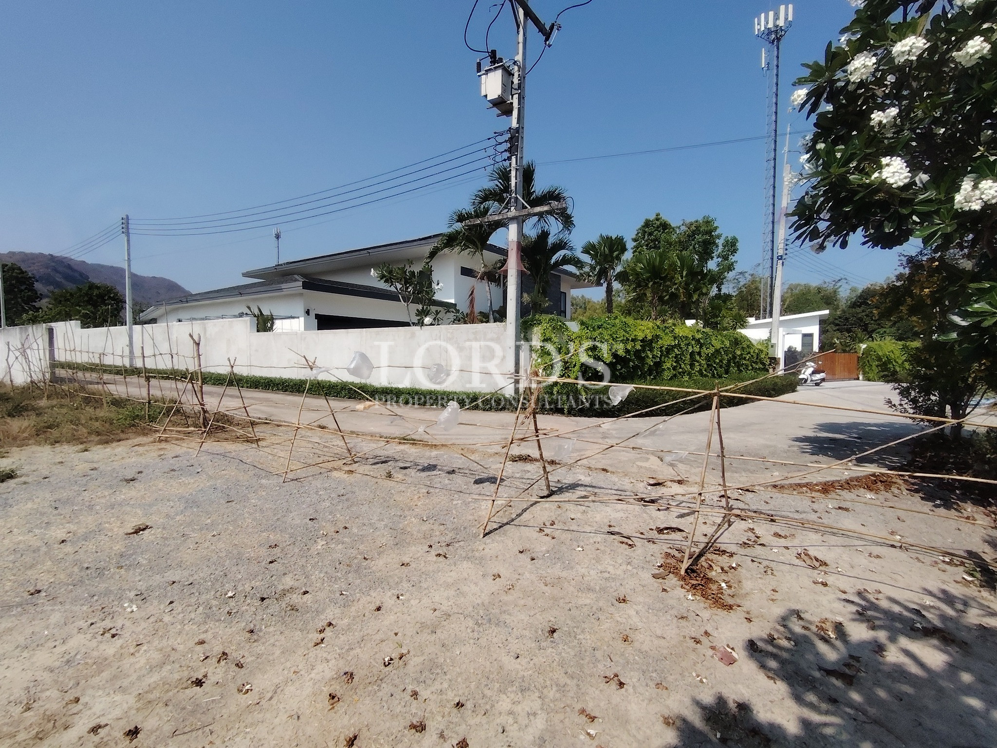 Empty land plot with boundary wall and pole