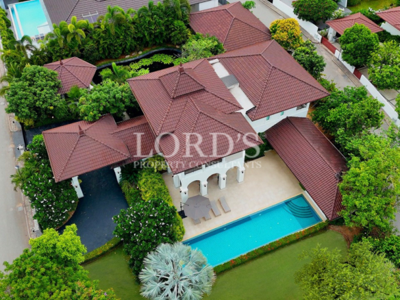 Aerial view of luxury villa with pool and tropical landscaping