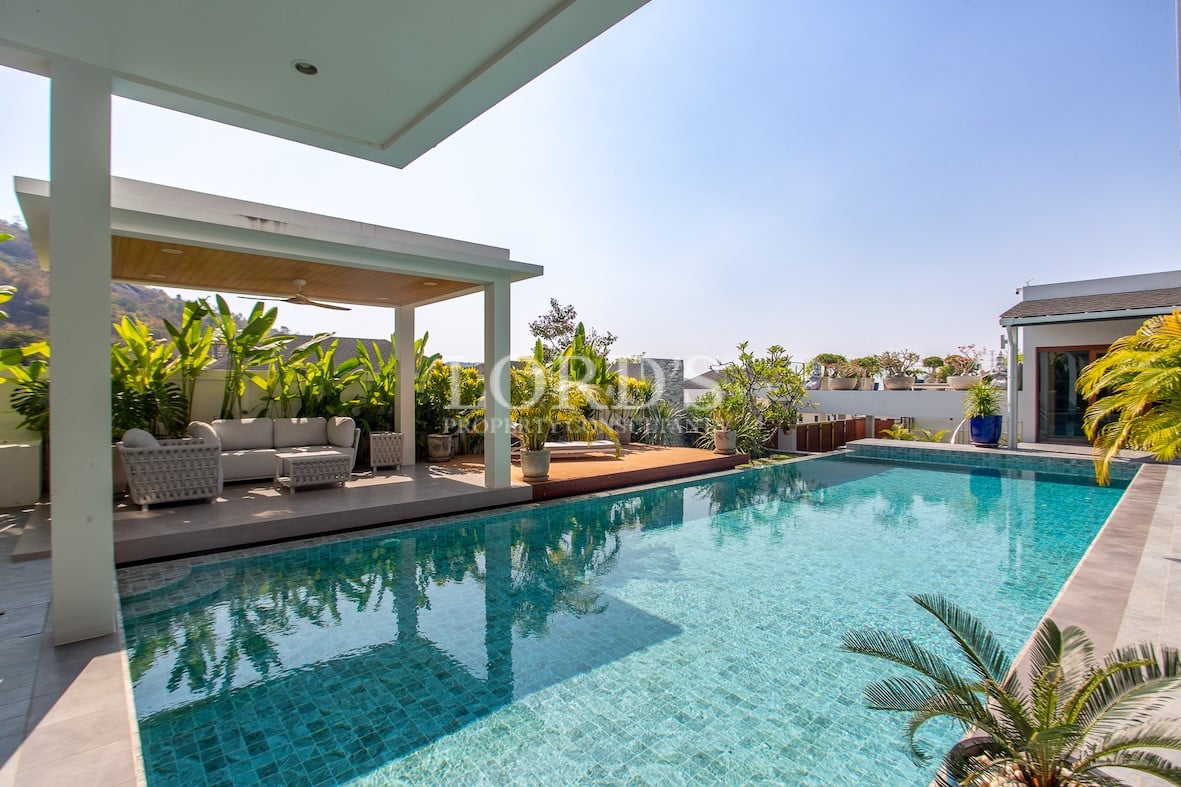 Luxury villa exterior with pool and garden