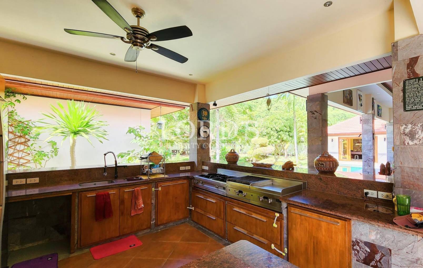 Kitchen with wooden cabinets and garden view
