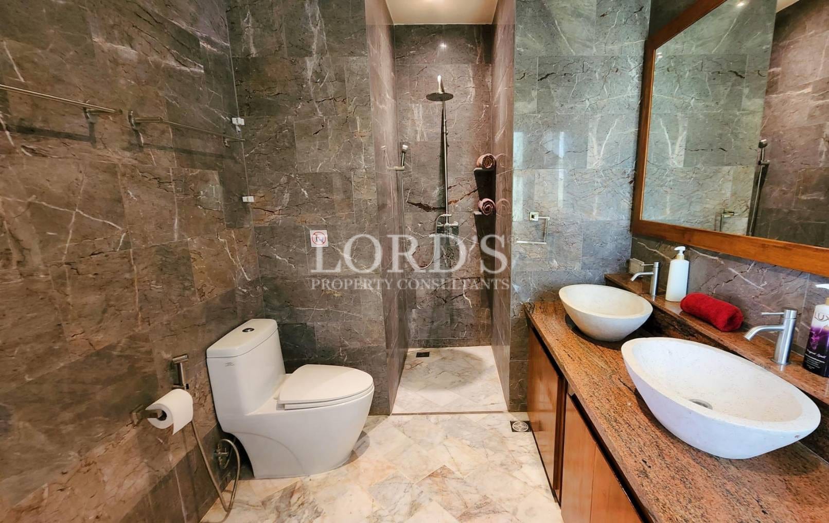 Bathroom with stone walls and modern fixtures