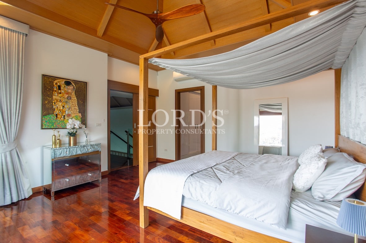 Bedroom with wooden floor and large bed