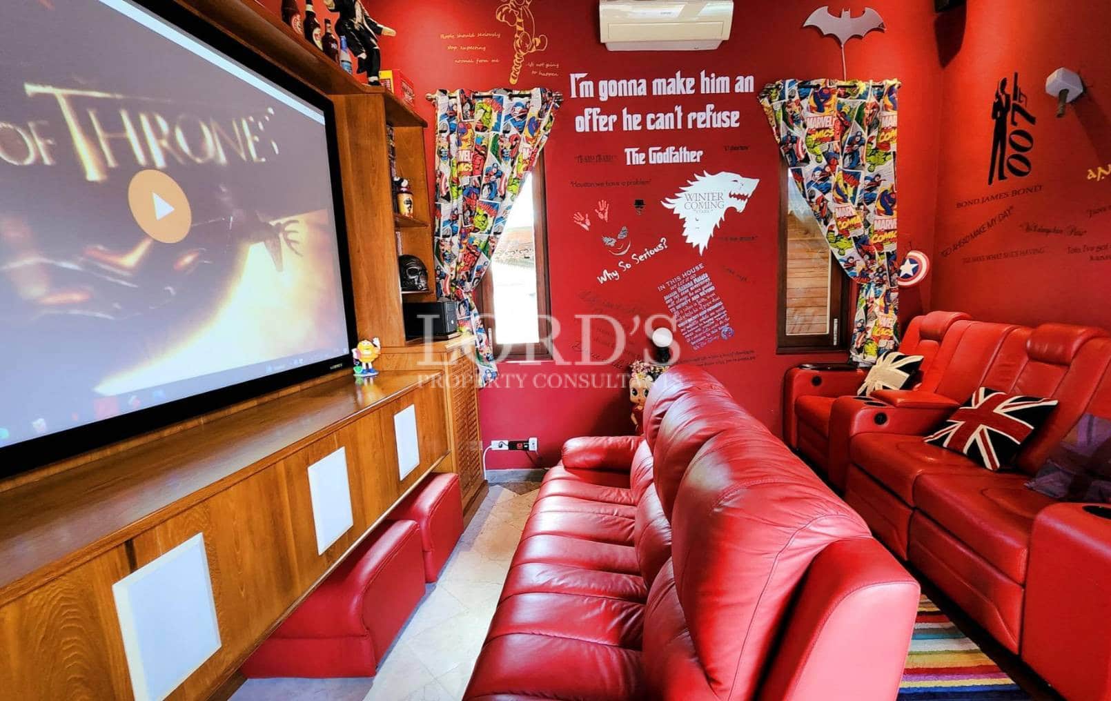 Entertainment room with red seating and decor