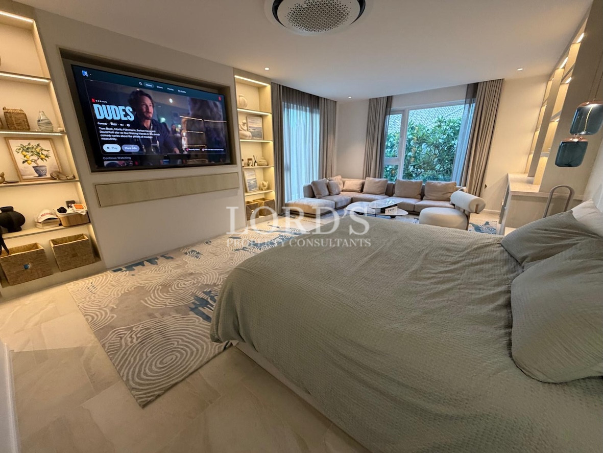 Bedroom with TV and large bed