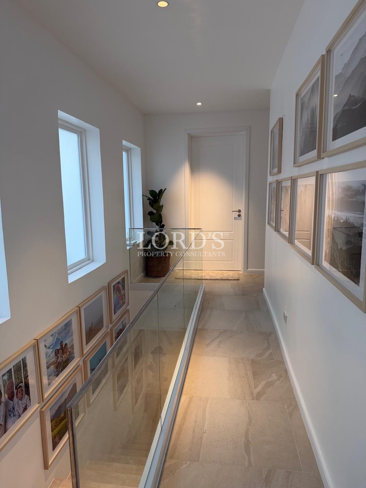 Hallway with wall art and lighting