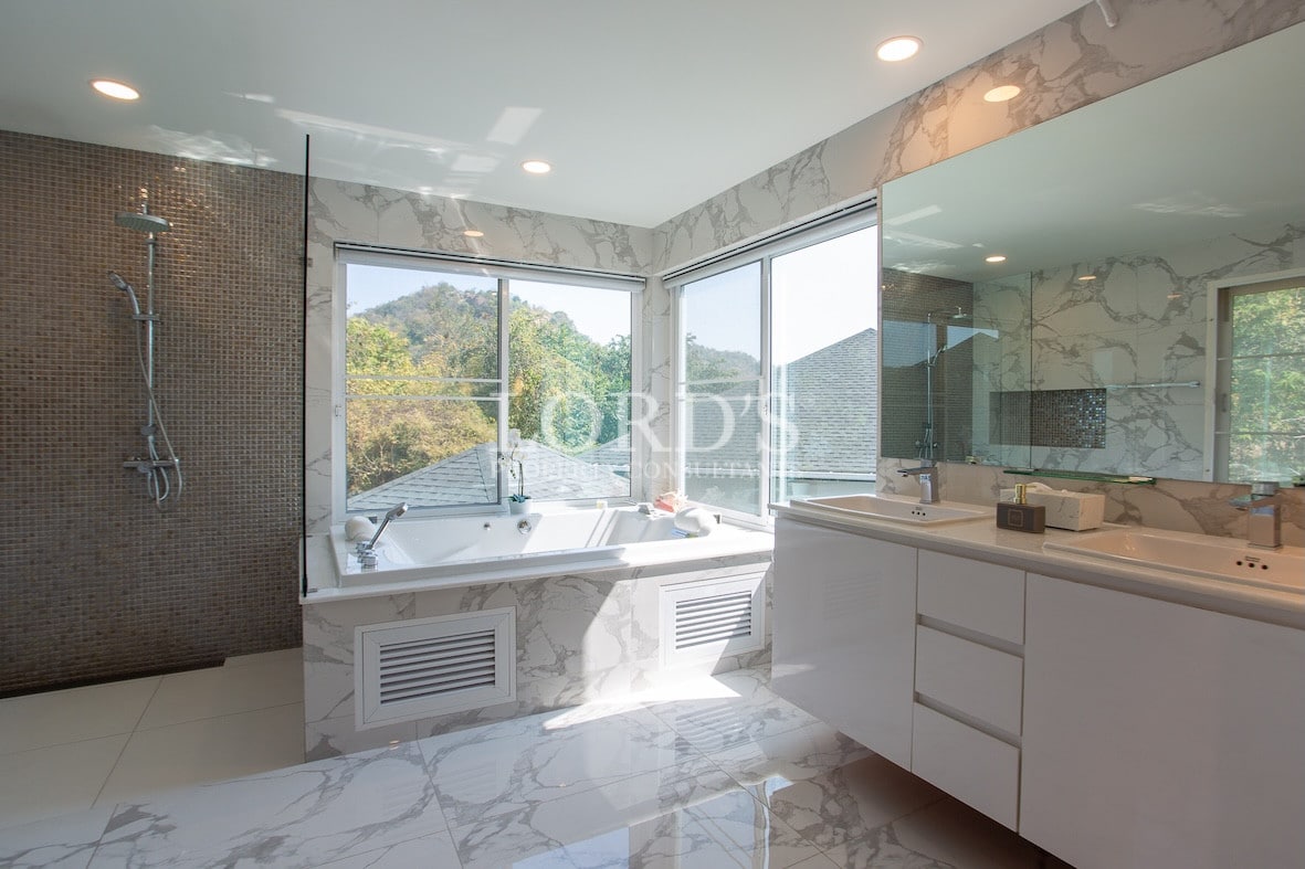 Bathroom with bathtub and glass shower