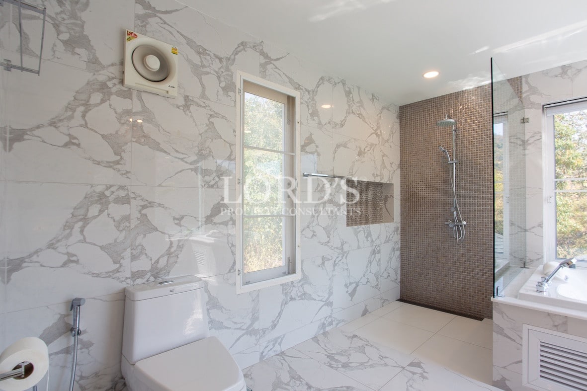 Bathroom with marble wall and shower