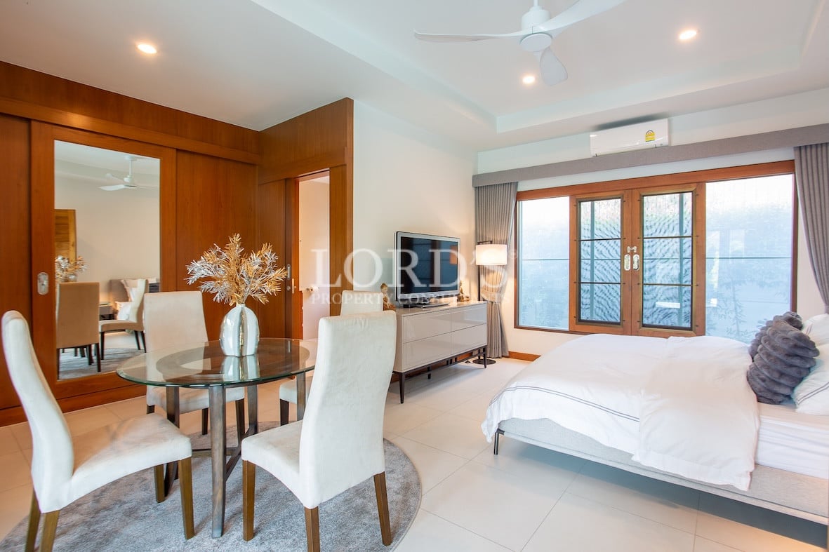 Bedroom with seating area and bed