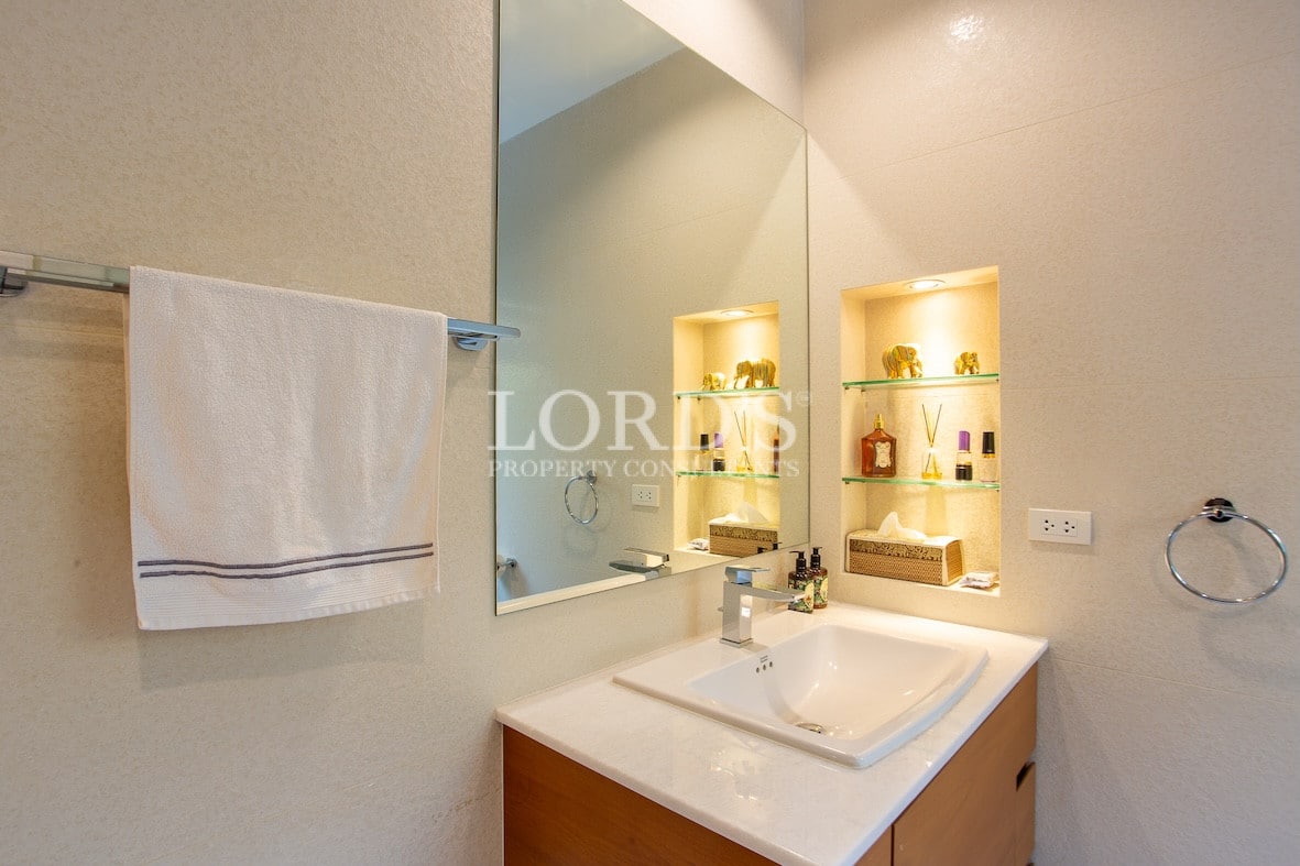Bathroom with vanity and mirror lighting