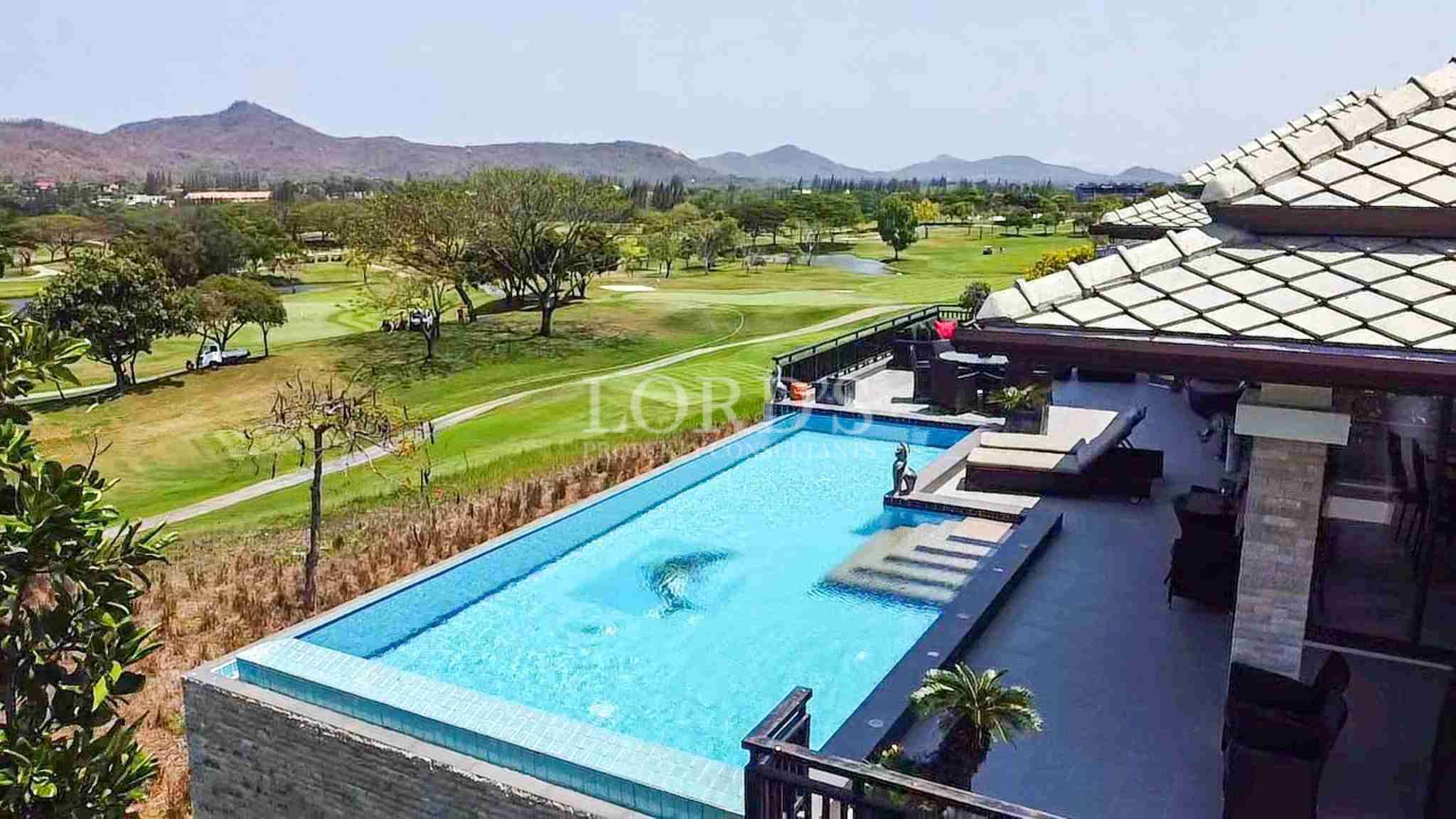 Luxury villa with infinity pool overlooking golf course and mountains