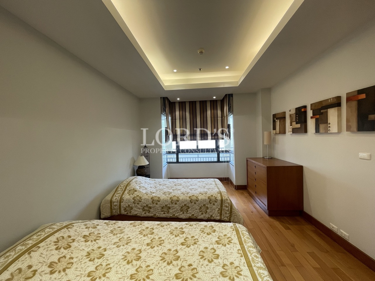 Bedroom with large bed and ceiling lights