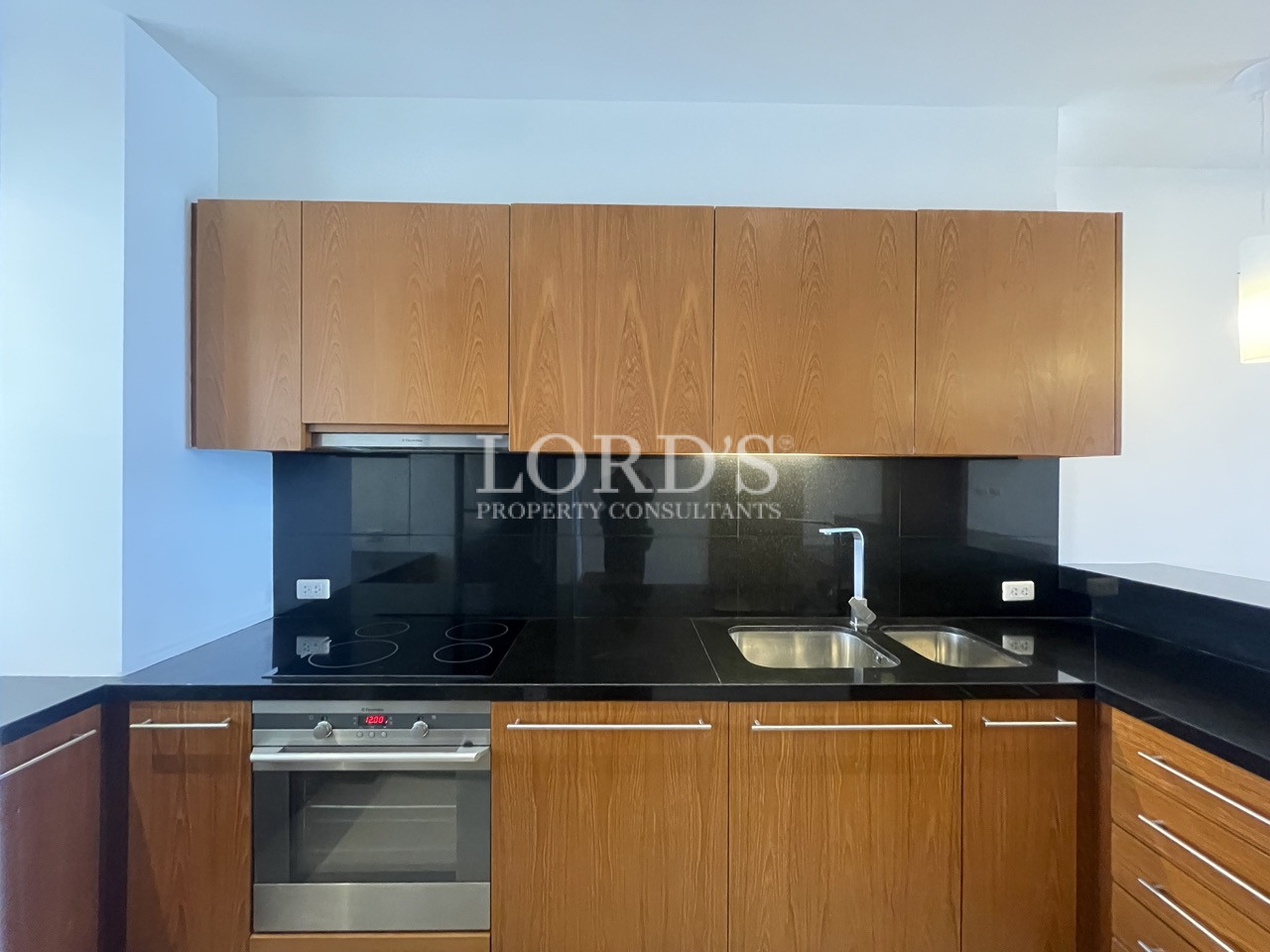 Kitchen with wooden cabinets and black backsplash