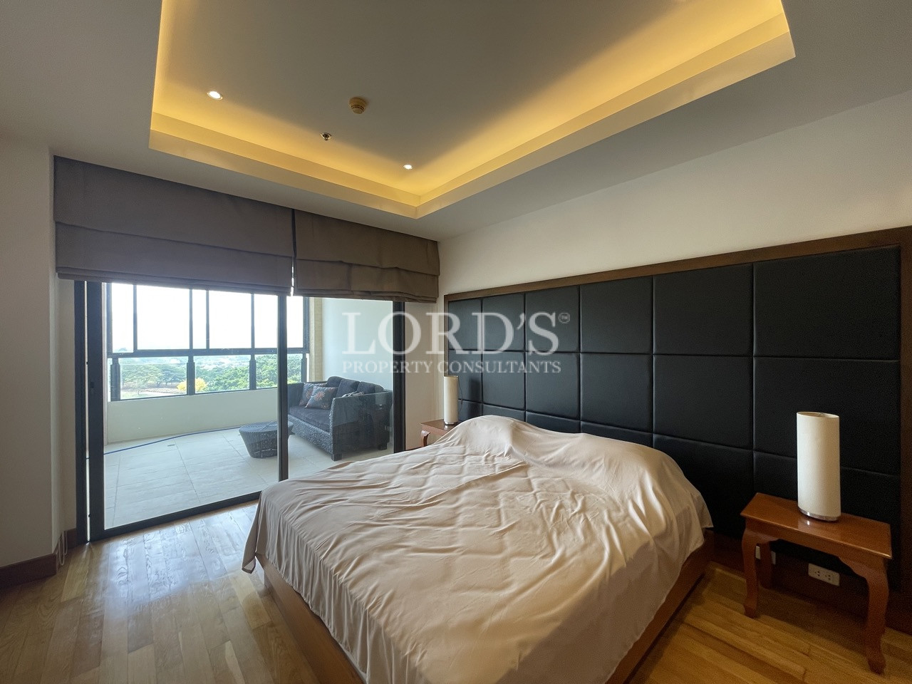 Bedroom with large windows and bed