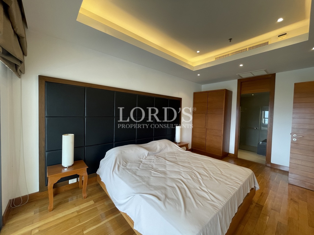 Bedroom with wooden floor and soft lighting