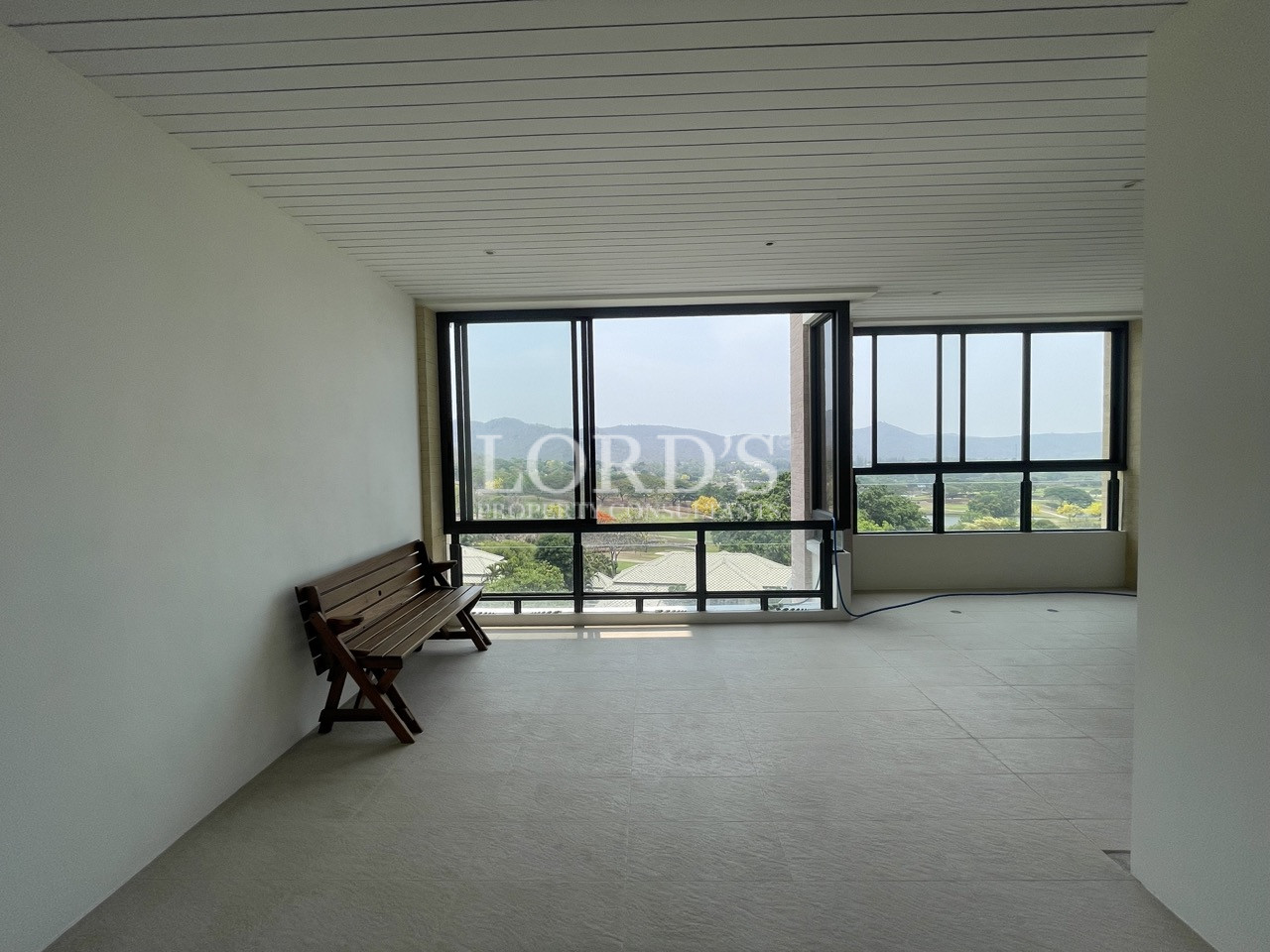 Empty room with large windows and outdoor view