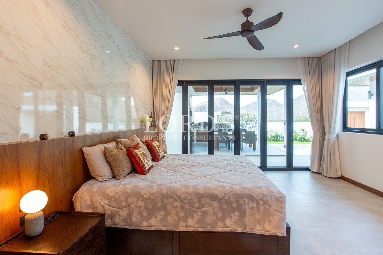 bedroom with large window and bed