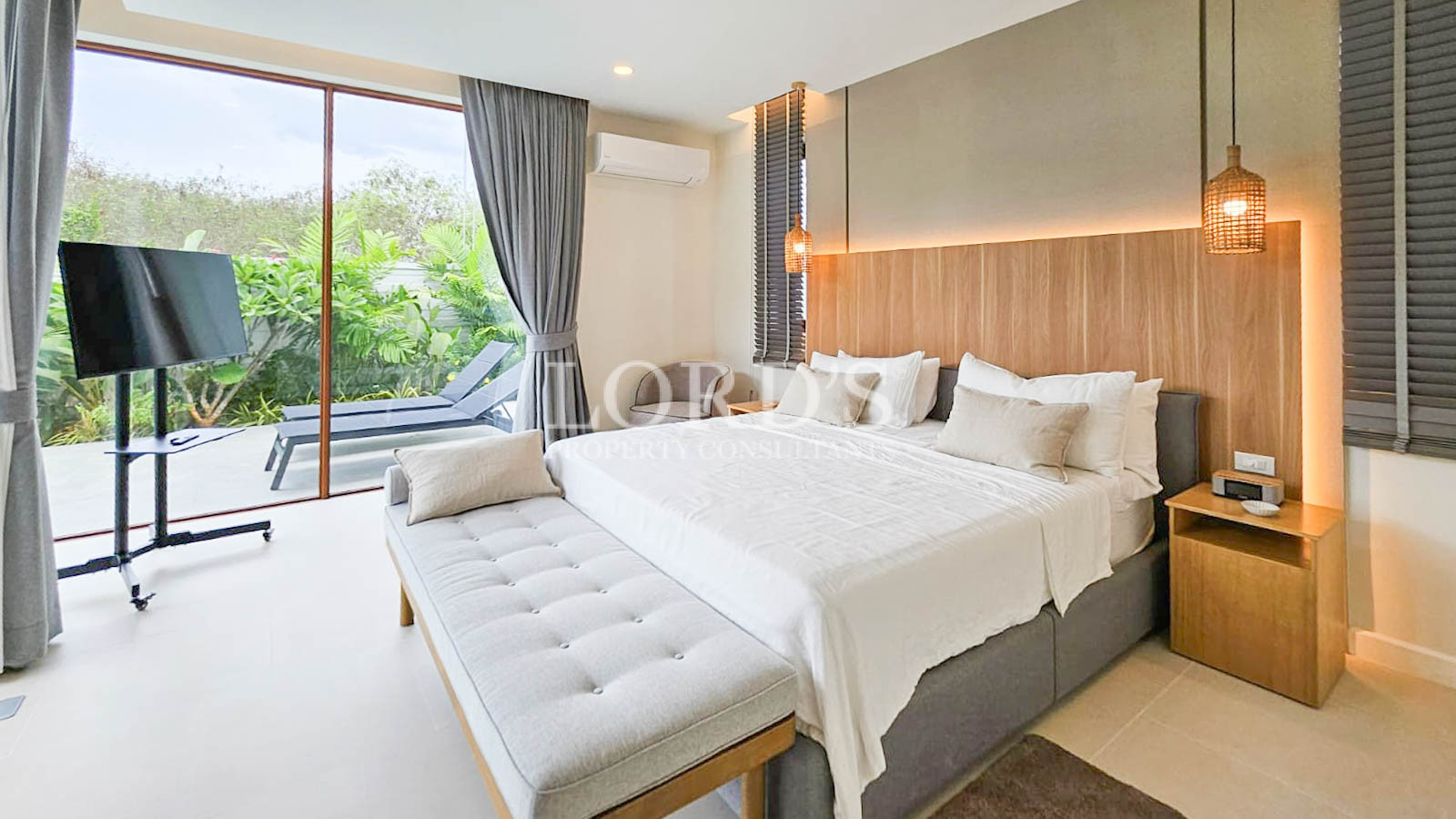 Bedroom with large window and greenery view