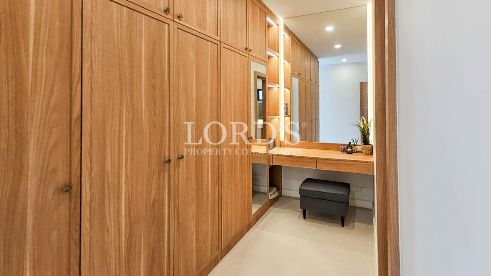 Walk-in wardrobe with wooden cabinets