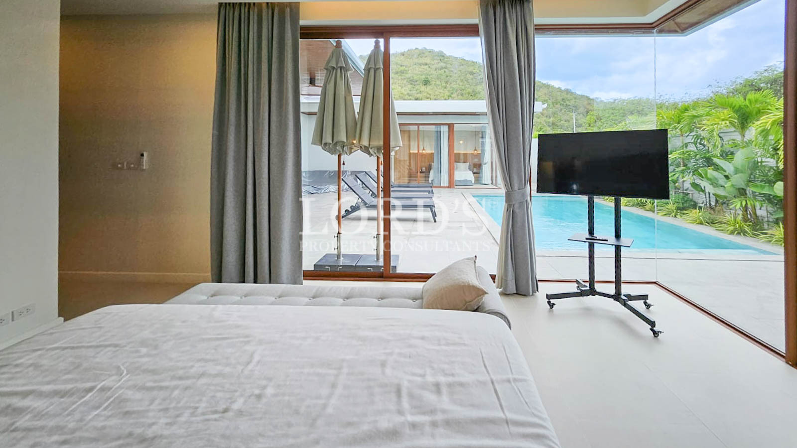 Bedroom with sliding doors and pool view
