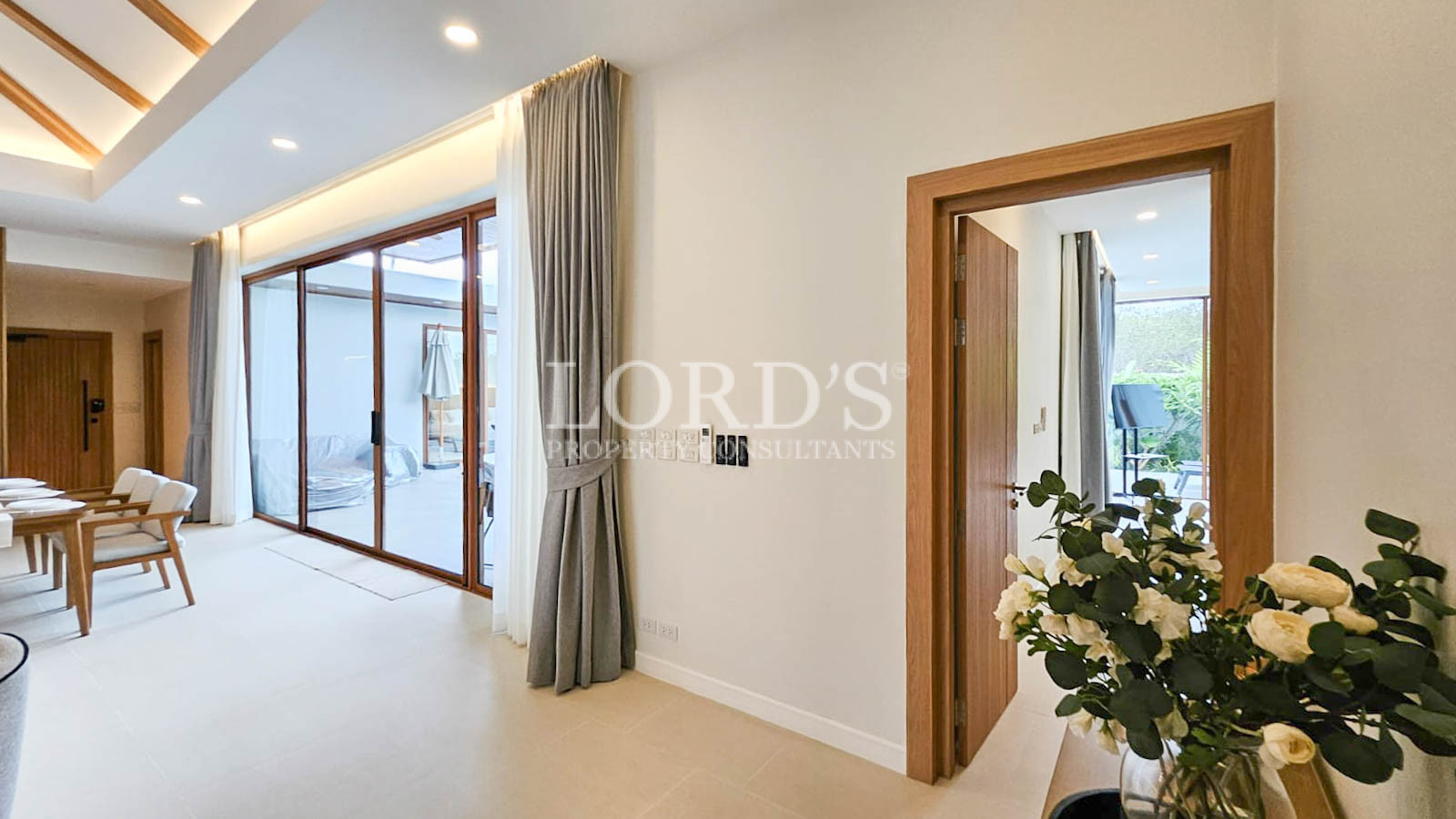 Bedroom entrance with wooden door and curtains