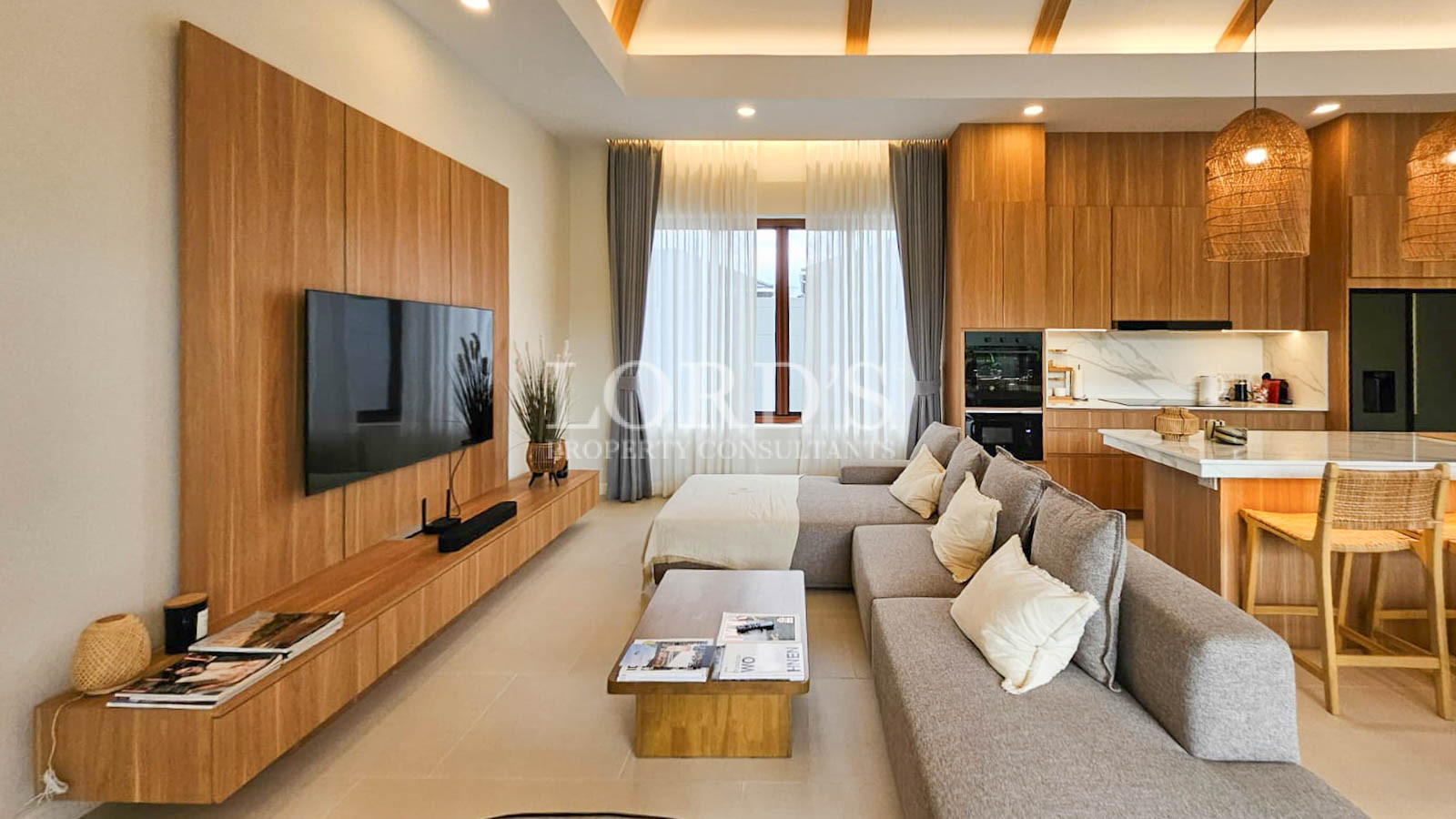 Living room with large sofa and TV wall