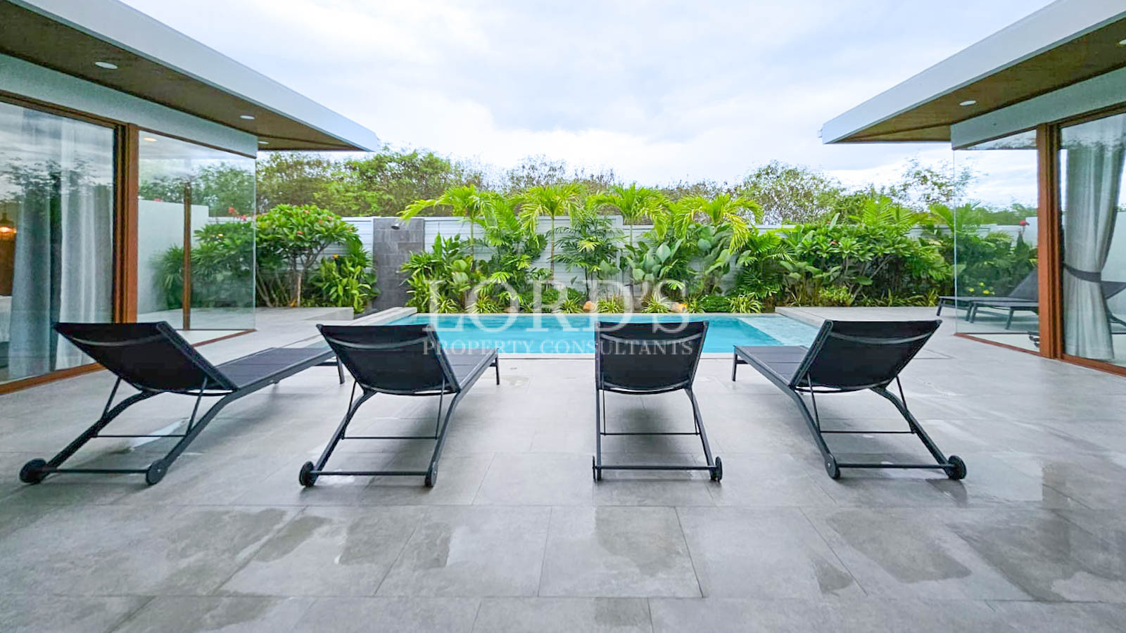 Outdoor lounge chairs near greenery