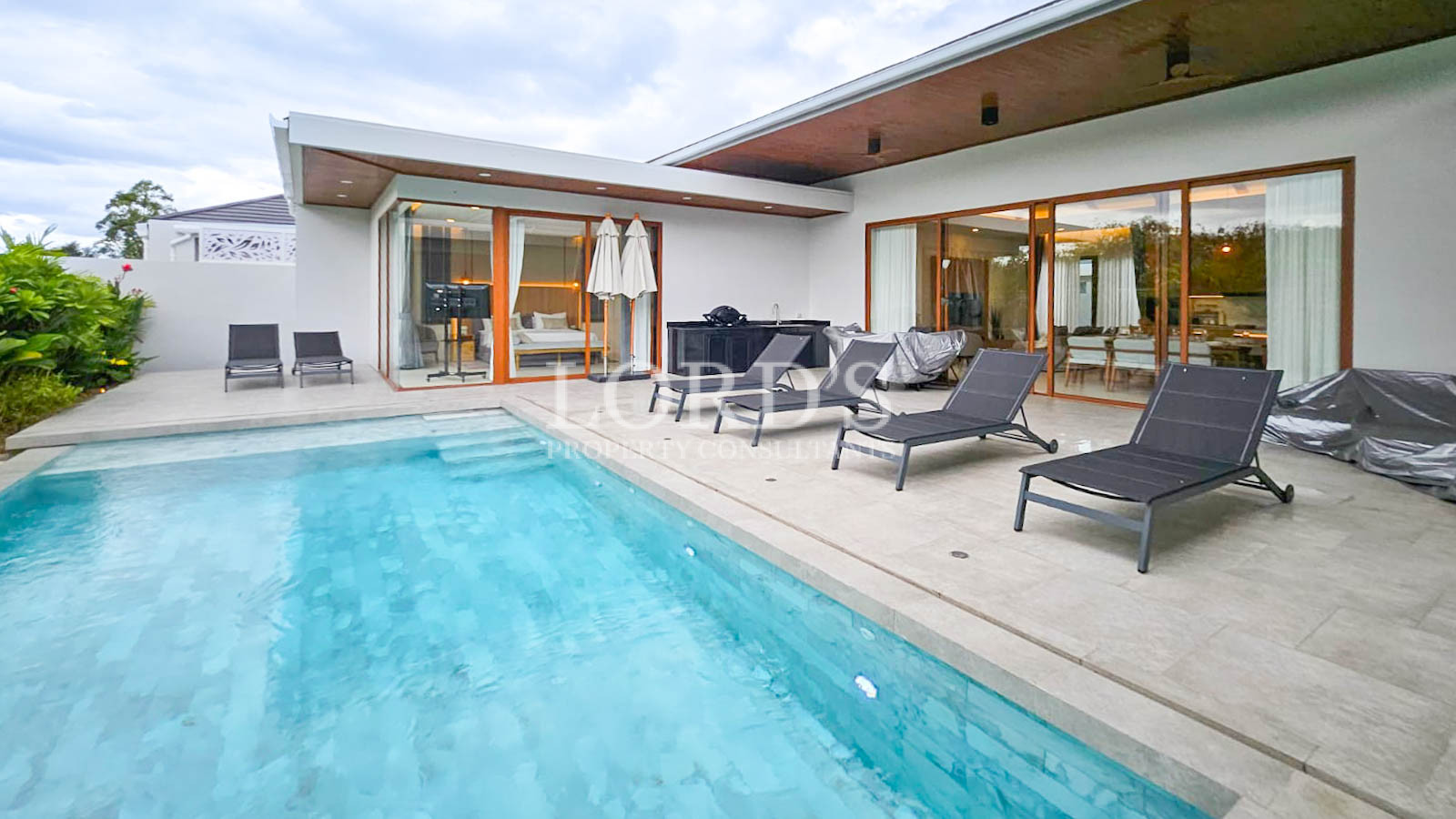 Poolside patio with lounge chairs