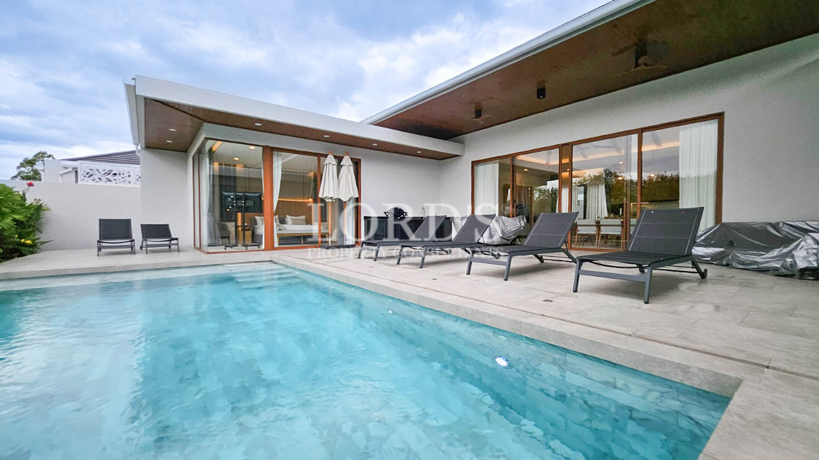 Swimming pool with modern villa exterior