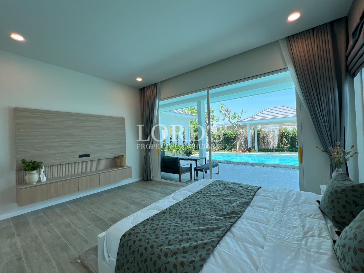 Bedroom with large window and pool view