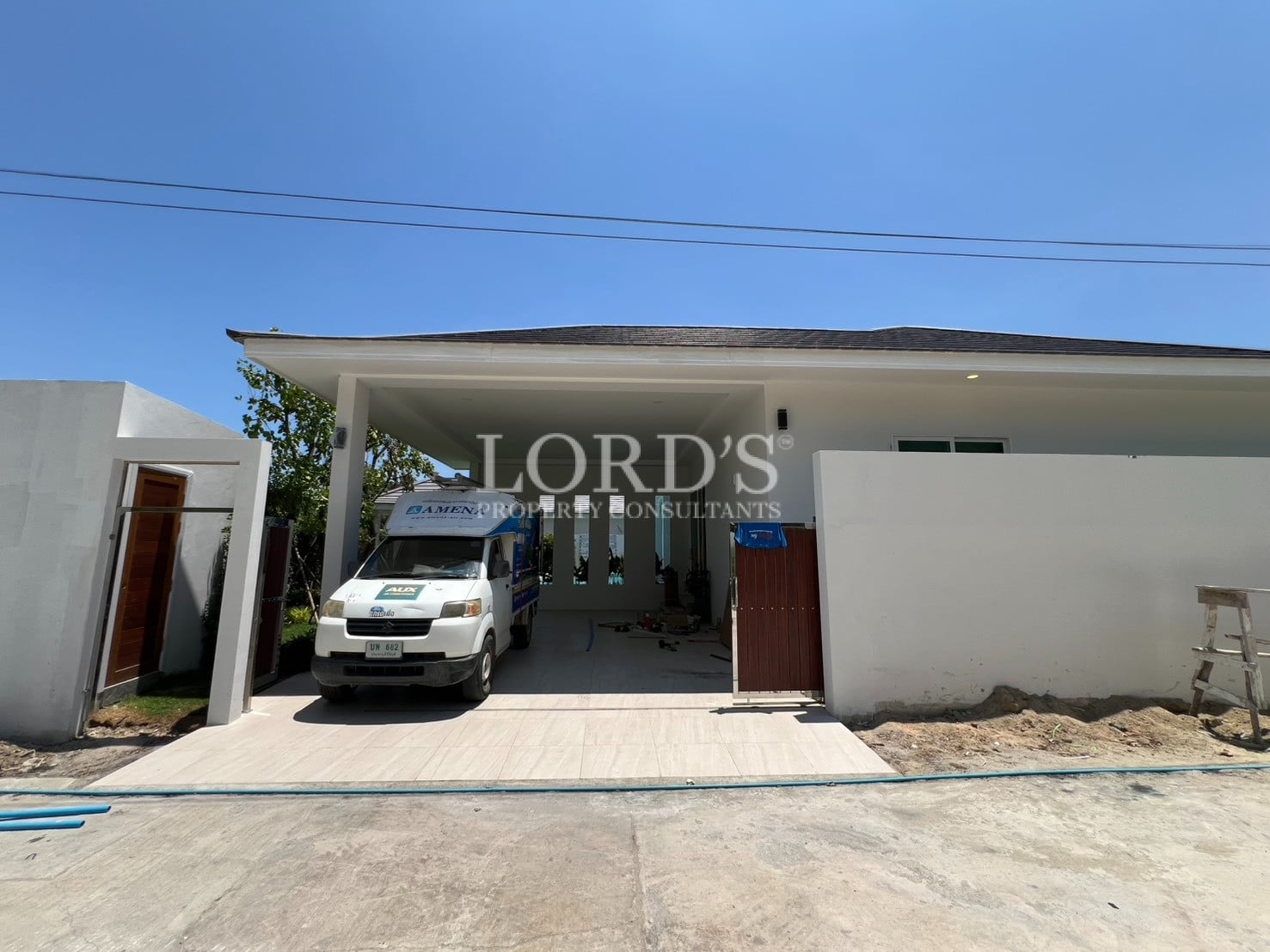 House entrance with driveway and car